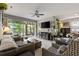 Spacious living room with a large flat screen TV, comfortable seating, and lots of natural light at 11655 Renaissance Blvd, Venice, FL 34293