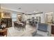 Open-concept space featuring a dining table and a bright kitchen with a large island and white cabinets at 11655 Renaissance Blvd, Venice, FL 34293