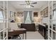 Office with dark wood furniture, French doors, neutral walls, and ample natural light at 11655 Renaissance Blvd, Venice, FL 34293