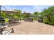 Expansive brick patio featuring multiple seating areas and umbrellas, creating a perfect outdoor oasis at 11655 Renaissance Blvd, Venice, FL 34293