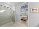 En-suite bathroom featuring a tiled shower and a view of the main bedroom, designed for convenience and privacy at 13032 Oriago St, Venice, FL 34293
