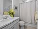 Bathroom with a modern vanity, patterned shower curtain and neutral walls at 13032 Oriago St, Venice, FL 34293