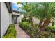 Inviting front entrance with stone walkway, lush landscaping, and a charming front door at 13032 Oriago St, Venice, FL 34293