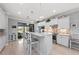 Bright kitchen with granite counters, white cabinets, and a center island with bar stool seating at 13032 Oriago St, Venice, FL 34293