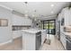 Modern kitchen island with granite countertops, stainless steel appliances, and stylish pendant lighting at 13032 Oriago St, Venice, FL 34293