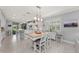 Well-lit open kitchen with an island, modern appliances, and a dining area at 13032 Oriago St, Venice, FL 34293