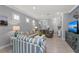 Inviting living room featuring striped sofas, neutral walls, and stylish decor at 13032 Oriago St, Venice, FL 34293