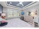 Comfortable main bedroom with tray ceilings and natural light coming through plantation shutters at 13032 Oriago St, Venice, FL 34293