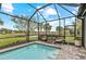 The screened pool offers clear blue water and comfortable seating with beautiful views of the community at 13032 Oriago St, Venice, FL 34293