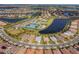 Stunning aerial view of a Primary-planned community featuring multiple lakes, lush landscaping, pools, and tennis courts at 13251 Borrego St, Venice, FL 34293