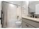 Elegant bathroom with a tub, shower, neutral tile, and vanity with a dark countertop at 13251 Borrego St, Venice, FL 34293