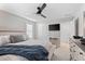 Bedroom features a ceiling fan, mounted TV, and access to the hallway at 13251 Borrego St, Venice, FL 34293