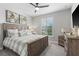 Comfortable bedroom featuring a ceiling fan, large window, and beach-themed decor at 13251 Borrego St, Venice, FL 34293