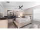 Relaxing bedroom with a ceiling fan, calming art, and warm lighting at 13251 Borrego St, Venice, FL 34293
