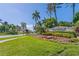 Welcome to Islandwalk! A beautifully landscaped community entrance with lush flowers and towering palm trees at 13251 Borrego St, Venice, FL 34293