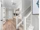 Bright foyer with hardwood floors, staircase, and decorative console table with mirror at 13251 Borrego St, Venice, FL 34293