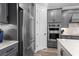 Modern kitchen featuring stainless steel appliances, gray cabinetry, and quartz countertops at 13251 Borrego St, Venice, FL 34293