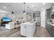 Beautiful kitchen with an island and modern stainless steel appliances adjacent to the living area at 13251 Borrego St, Venice, FL 34293