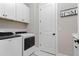 Neat laundry room includes front-loading washer/dryer and upper cabinets for storage at 13251 Borrego St, Venice, FL 34293