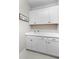 Well-organized laundry room with a sink, cabinets, and neutral decor at 13251 Borrego St, Venice, FL 34293