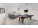 Spacious living room with a pool table, comfortable seating, and a ceiling fan at 13251 Borrego St, Venice, FL 34293