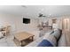 Open-concept living room with a pool table, comfortable seating, and a TV at 13251 Borrego St, Venice, FL 34293