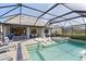 A stunning screened-in pool featuring a spa and lounging chairs, perfect for relaxation and outdoor enjoyment at 13251 Borrego St, Venice, FL 34293