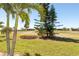 Expansive backyard with lush lawn and mature trees, offering a serene and private retreat at 14 Windward Ter, Placida, FL 33946