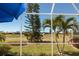 Screened patio overlooking the backyard and nearby properties at 14 Windward Ter, Placida, FL 33946