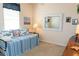 Bedroom featuring nautical themed bedding and decor, bright natural lighting, and ample wall art at 14 Windward Ter, Placida, FL 33946