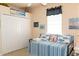 Comfortable bedroom featuring nautical themed bedding and decor, white closet doors, and ample wall art at 14 Windward Ter, Placida, FL 33946