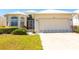 Inviting one-story home with a two-car garage, complemented by mature landscaping at 14 Windward Ter, Placida, FL 33946