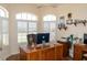 Comfortable home office with a large desk and shuttered windows providing natural light at 14 Windward Ter, Placida, FL 33946