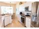 Bright kitchen features stainless steel appliances, breakfast bar, and tile flooring at 14 Windward Ter, Placida, FL 33946