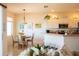Kitchen and breakfast nook with white cabinetry, stainless appliances and pendant lighting at 14 Windward Ter, Placida, FL 33946