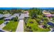 Aerial view of a home nestled amongst manicured lawns, mature trees and shrubbery in this golf course community at 1400 Colony Pl, Venice, FL 34292