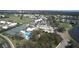Aerial view featuring golf course, community pool, and Waterford Primary Community Association at 1400 Colony Pl, Venice, FL 34292