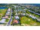 Scenic aerial view showcases a community with houses surrounding a golf course and multiple ponds at 1400 Colony Pl, Venice, FL 34292