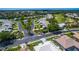 Aerial view of a residential community with golf course, pool, and mature trees at 1400 Colony Pl, Venice, FL 34292