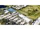 Aerial view of a golf course and Waterford Golf Club with tennis courts and a parking lot at 1400 Colony Pl, Venice, FL 34292