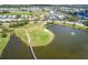 Breathtaking aerial view of a golf course and lake surrounding beautiful homes in a gated community at 1400 Colony Pl, Venice, FL 34292