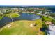 Panoramic aerial shot of a golf course, serene lake, and houses in an upscale residential area at 1400 Colony Pl, Venice, FL 34292
