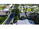 Aerial view of homes in a lakeside community with manicured lawns and palm tree landscaping at 1400 Colony Pl, Venice, FL 34292