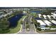 Aerial view of the community entrance and landscaped median with palm trees and water features at 1400 Colony Pl, Venice, FL 34292