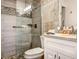 Updated bathroom with a glass enclosed shower, mosaic tile accents, and modern vanity for a spa-like experience at 1400 Colony Pl, Venice, FL 34292