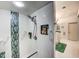 Modern shower with sleek fixtures, built-in shelving, and door leading to the bathroom at 1400 Colony Pl, Venice, FL 34292