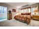 Bedroom featuring a king-size bed with decorative pillows and bedside tables with lamps at 1400 Colony Pl, Venice, FL 34292