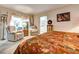 Bedroom featuring an ensuite sitting room and bathroom with decorative furniture and decor at 1400 Colony Pl, Venice, FL 34292
