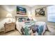 Cozy bedroom featuring a floral quilt, art, and wicker bedside tables for a charming, relaxed space at 1400 Colony Pl, Venice, FL 34292