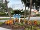 Inviting Centennial Park sign surrounded by colorful foliage, nestled between mature trees and manicured landscaping at 1400 Colony Pl, Venice, FL 34292